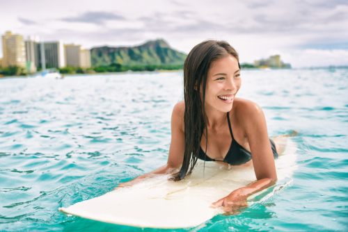 Girl on surfboard floating in ocean