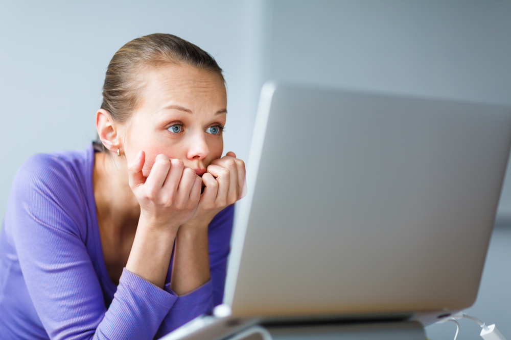 Girl looking into laptop screen.