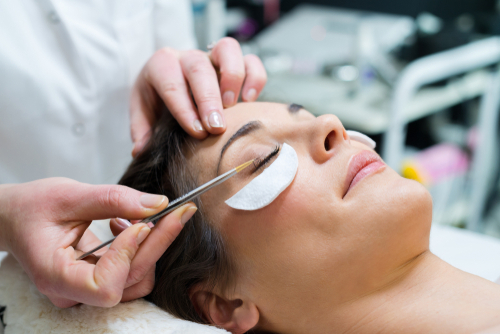 woman getting makeup on eye 