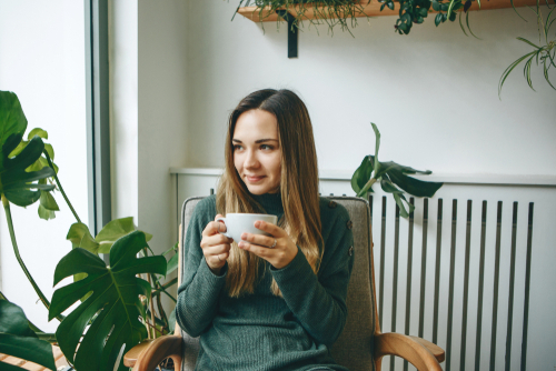 woman drinking cup of coffee