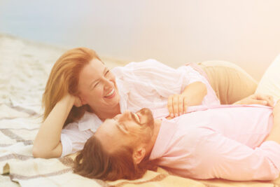 Couple laughing on the beach