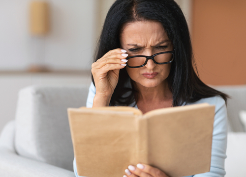 woman trying to read with glasses 