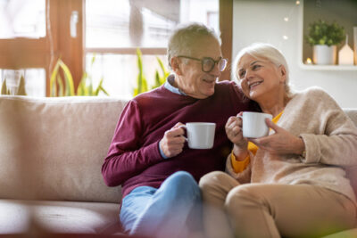 Couple sitting on a couch and drinking tea together