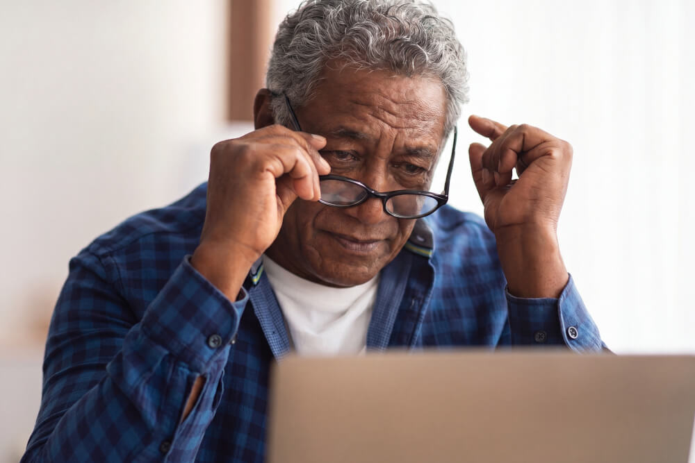 Elderly Man Adjusting Glasses